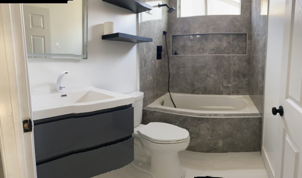 Bathroom remodel with tub, tile surround and floating vanity