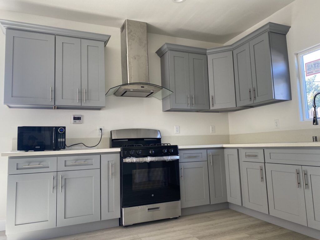 Kitchen remodel with gray shaker cabinets and stainless range