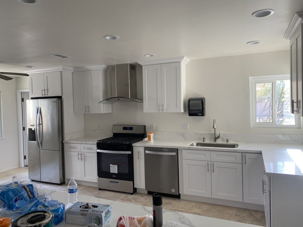 Kitchen remodel with white cabinets and stainless appliances