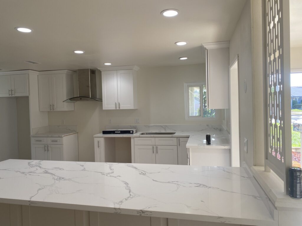 Kitchen remodel with white cabinets and quartz countertops