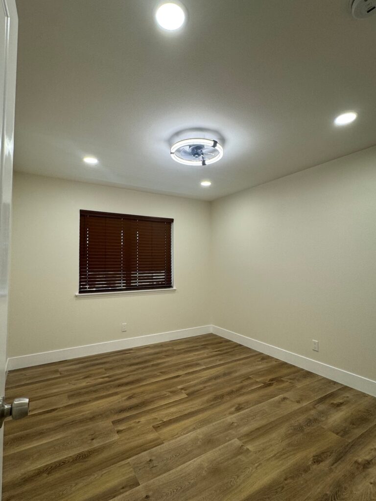 Bedroom with new flooring and lighting, Anaheim home remodel